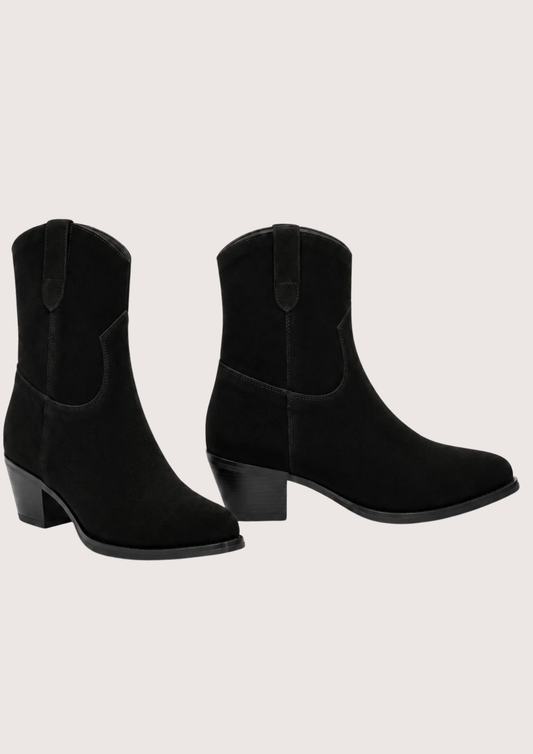 A pair of black suede western-style ankle boots with low block heels, shown against a solid off-white background.