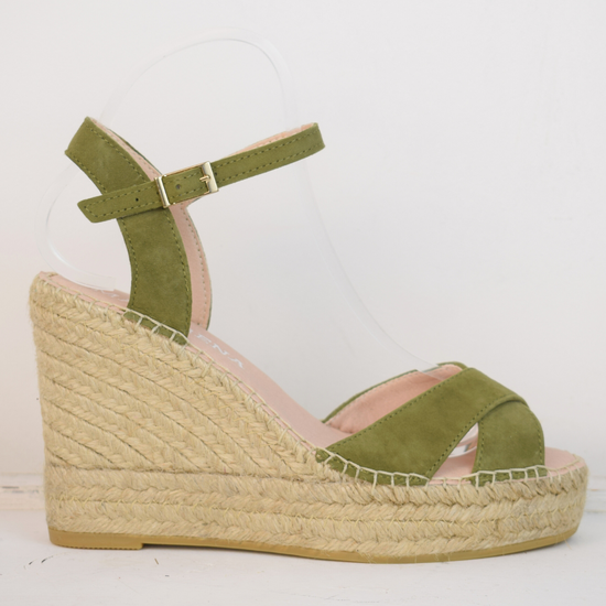 Wedge sandals with a green cross cover on the toes