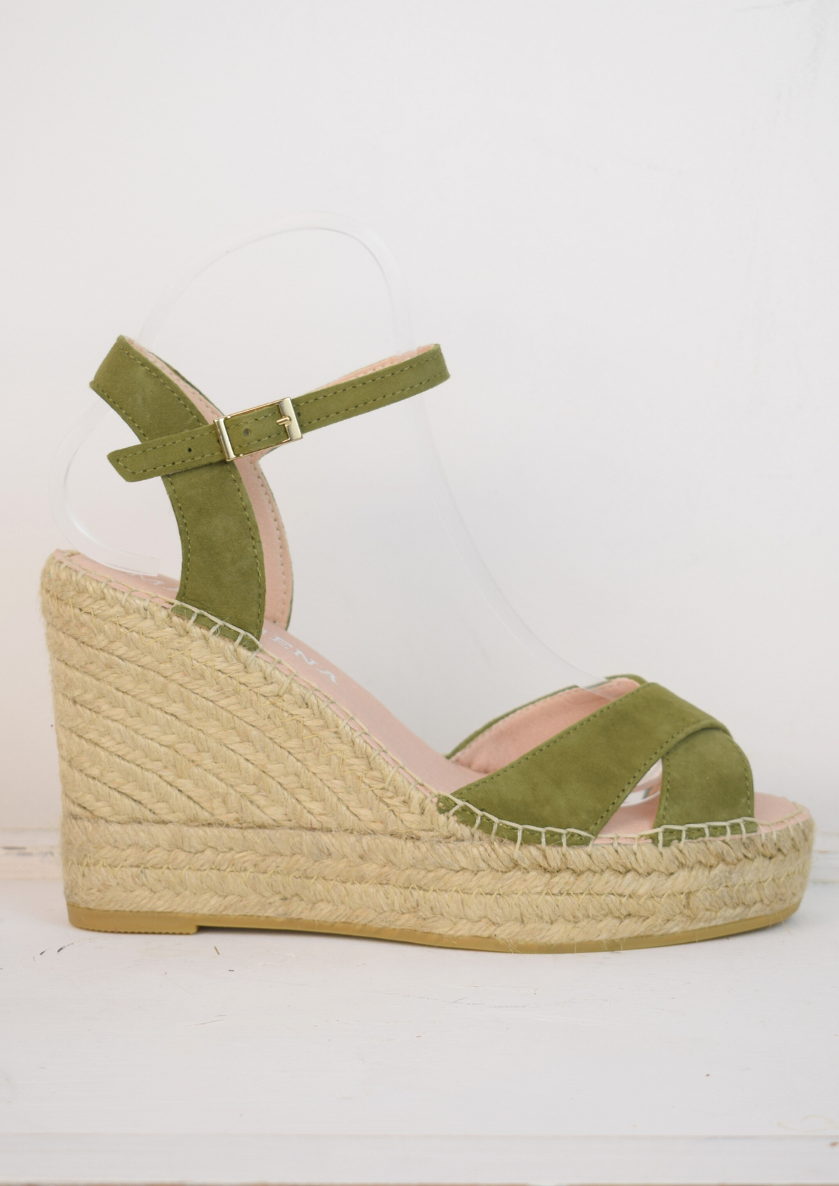 Wedge sandals with a green cross cover on the toes