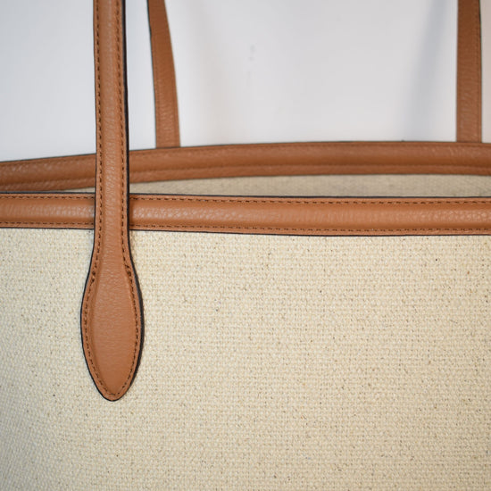 Neutral canvas totoe with tan leather trim