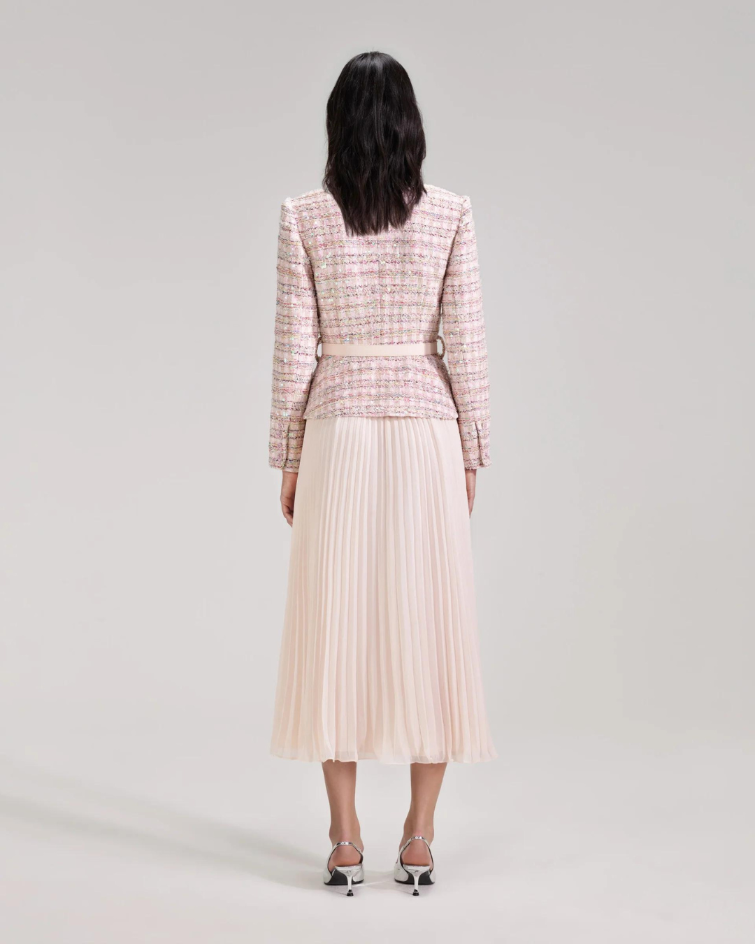 Shimmery pink boucle fitted collarless jacket with V neck detachable belt with soft pink pleated midi skirt