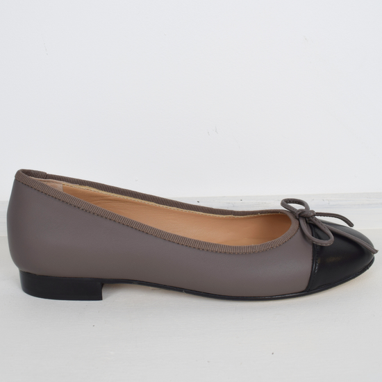 Taupe ballet pump with black toe and bow detail