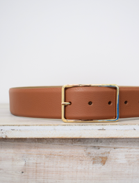 Wide tan belt with thin gold buckle 