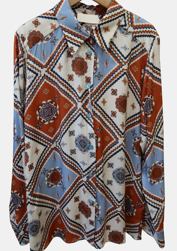 Patterned shirt with geometric blue orange and white design on a white background