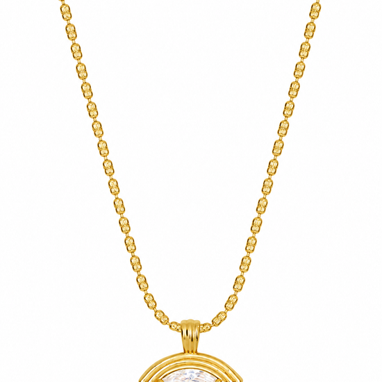 A gold chain necklace with a small oval pendant featuring a clear central stone, displayed against a plain white background.