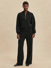 Quarter zip and slightly cropped black sweat top with shawl collar and V neckline from varley model shot