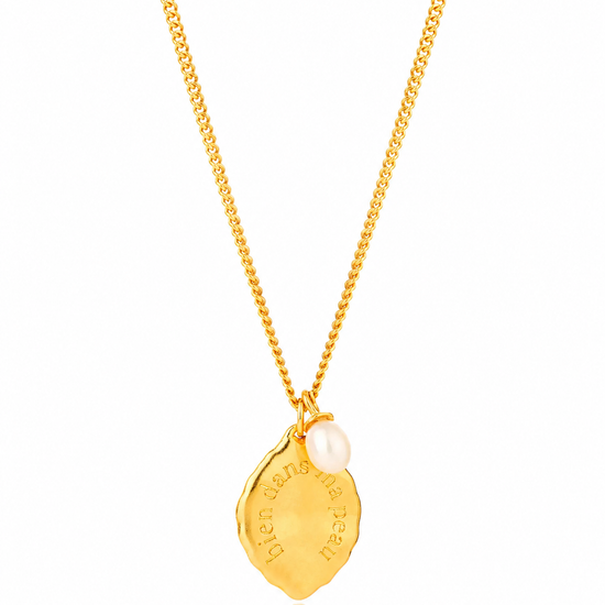 Gold necklace with a pendant on a white background