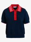 Navy polo shirt with red collar and buttons on a white background