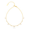 A delicate gold chain necklace with small clear rectangular gemstones spaced along the front, displayed on a clean white background.