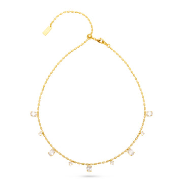 A delicate gold chain necklace with small clear rectangular gemstones spaced along the front, displayed on a clean white background.