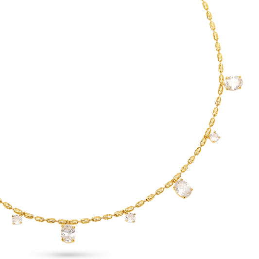 A delicate yellow gold necklace featuring small oval-cut stones along the chain and several larger clear rectangular gemstones, displayed on a clean white background.