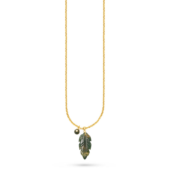 A delicate gold chain necklace featuring a carved green leaf pendant with gold detailing and a small gold bead accent, shown against a plain white background.
