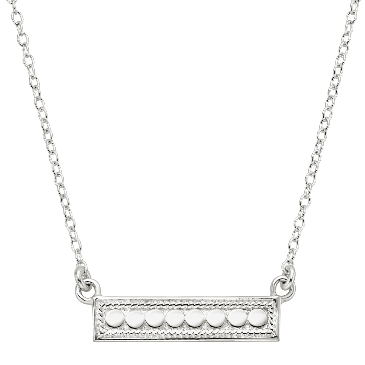 Silver necklace with a bar pendant on a white background