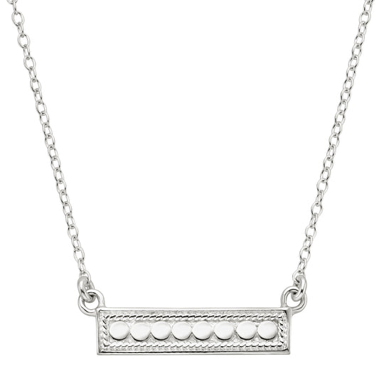 Silver necklace with a bar pendant on a white background