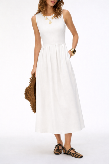 Woman wearing a white sleeveless dress holding a brown jacket on a white background