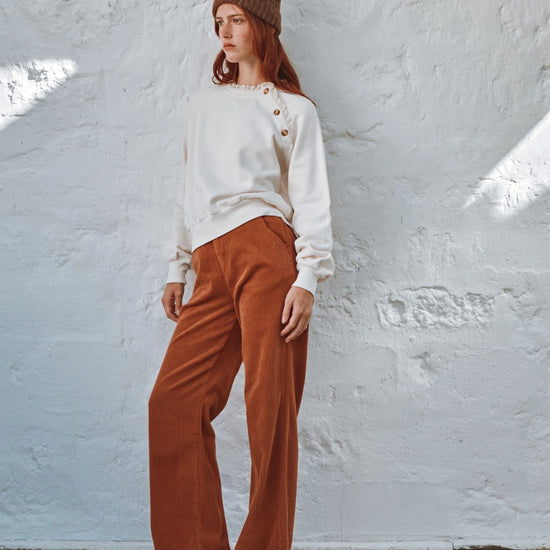 round frill neck cream sweatshirt with button shoulder detailing model shot