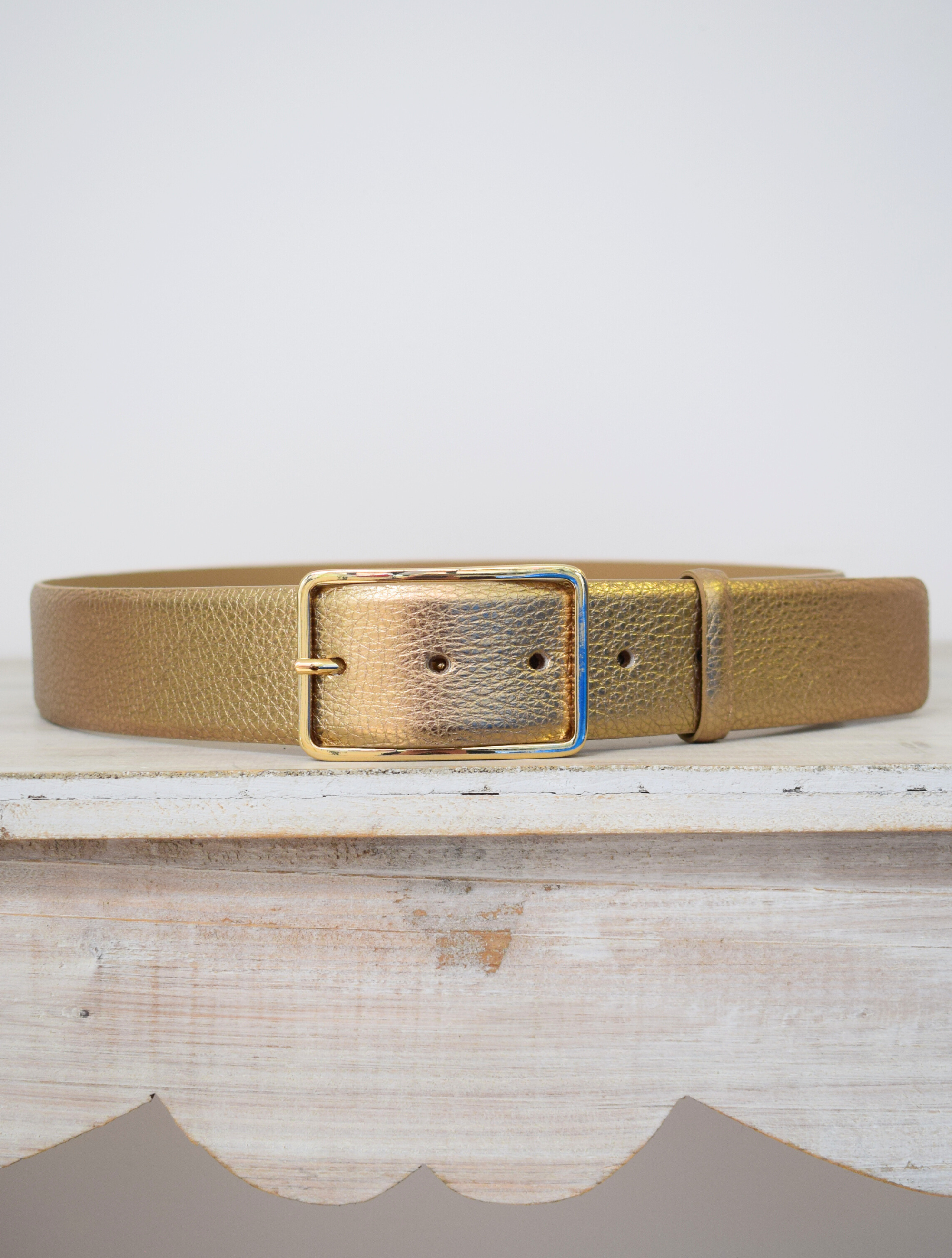 Wide gold belt with thin gold buckle 