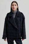 dark grey check jacket with wide collar and straps on cuffs and shoulders