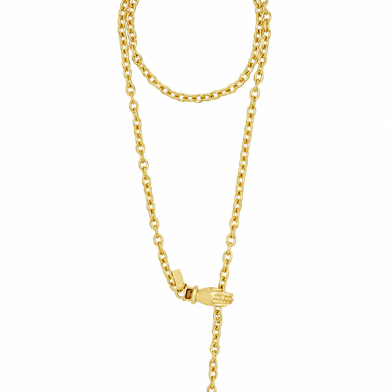 A gold chain necklace with a small hand-shaped charm and an adjustable drop tail, displayed on a clean white background.