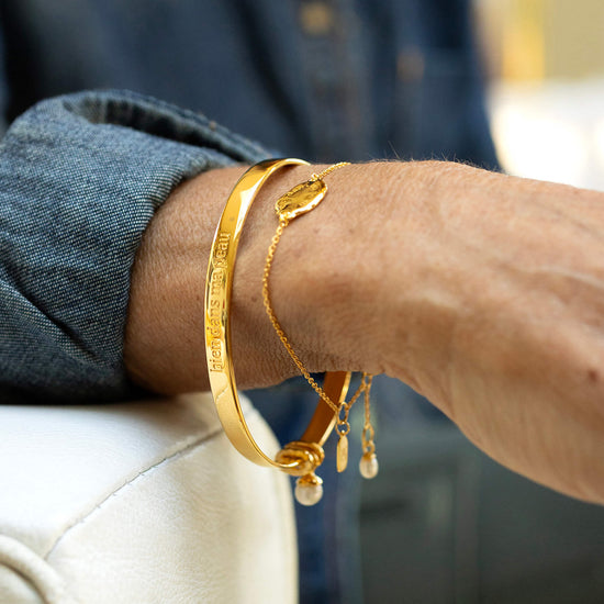 Gold bangle on wrist 