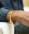 Gold bangle on wrist 