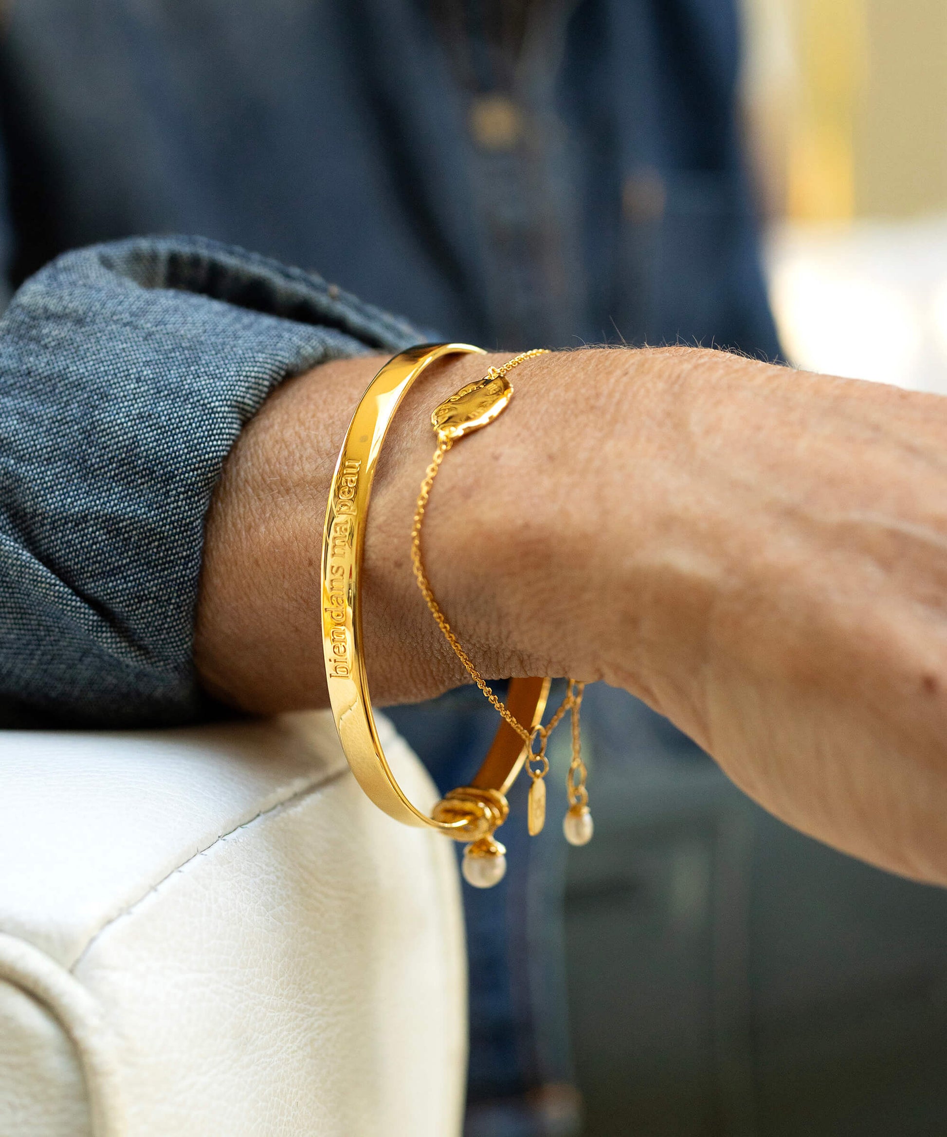 Gold bangle on wrist 
