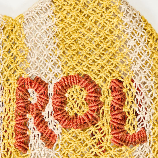 yellow stripe straw bag with slogan on white background zoomed in
