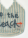 white and blue stripe straw bag with slogan on a white background
