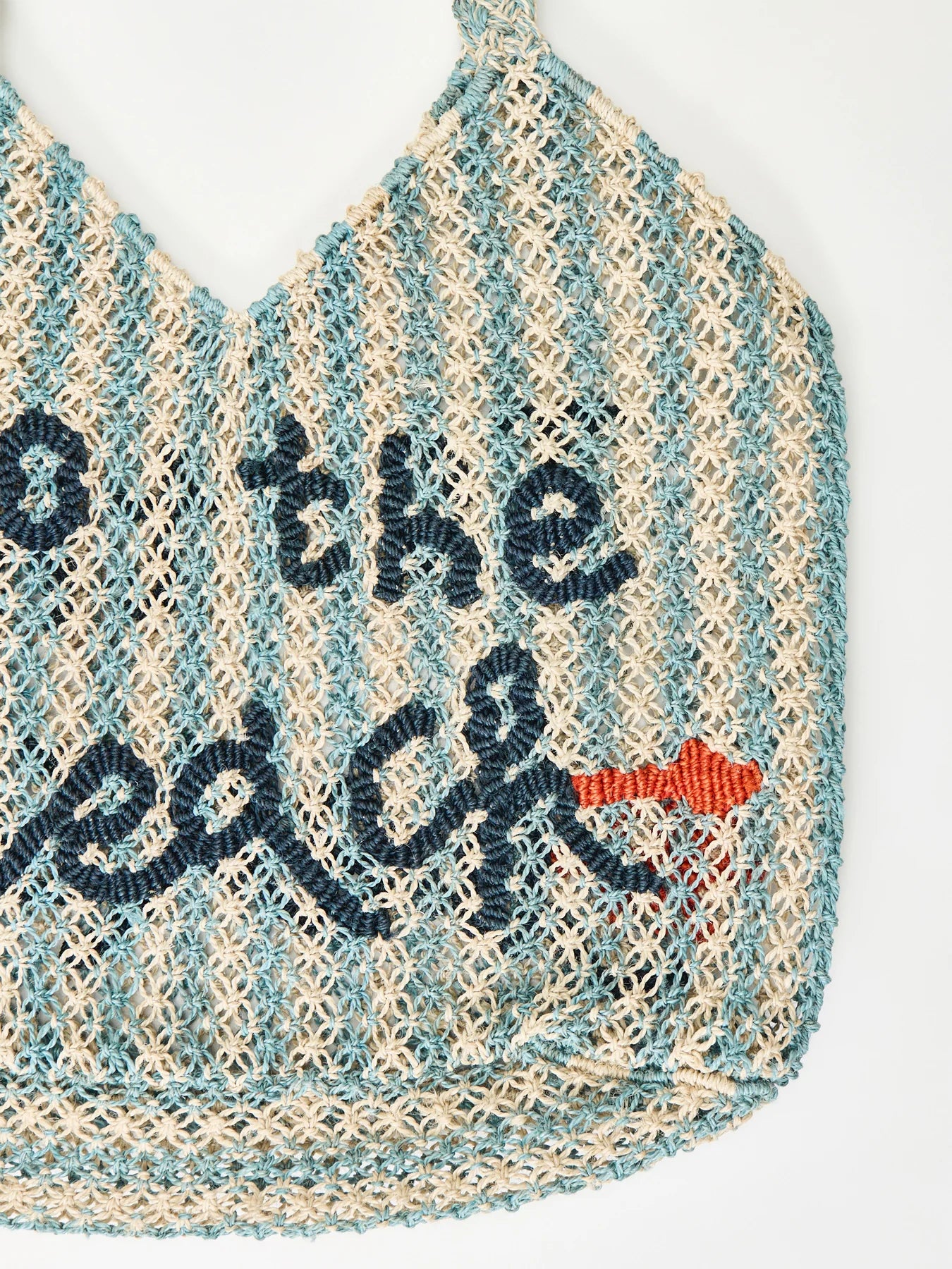 white and blue stripe straw bag with slogan on a white background
