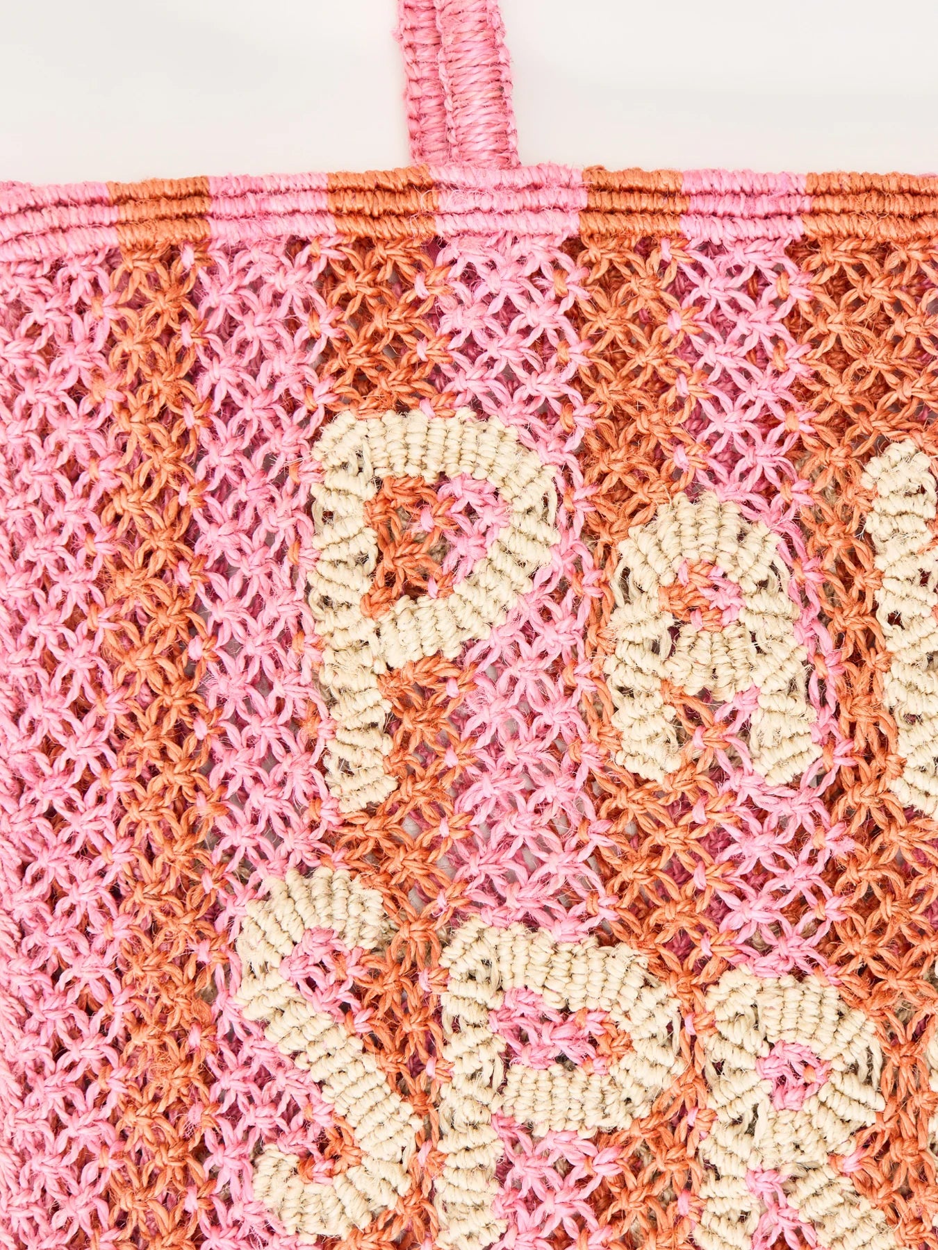 pink and orange string bag with slogan on a white background zoomed in