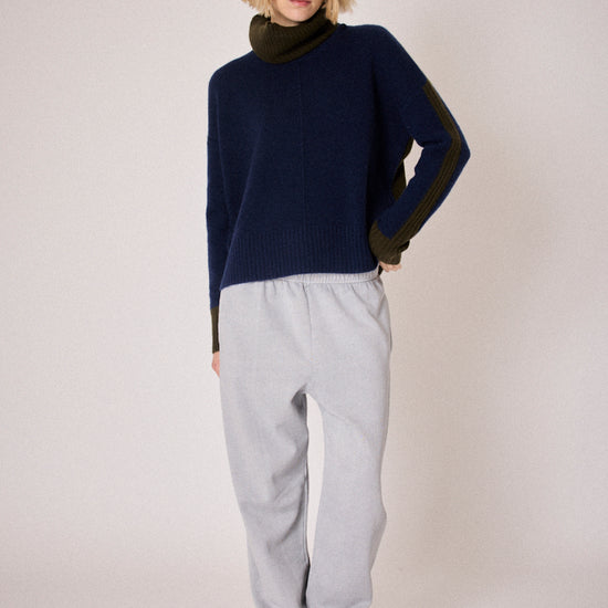 navy combination turtleneck with brown segments and rib detailing model shot