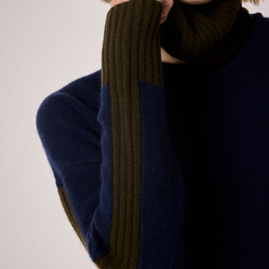 navy combination turtleneck with brown segments and rib detailing close up