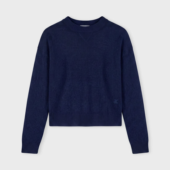 Navy blue sweater on a grey background