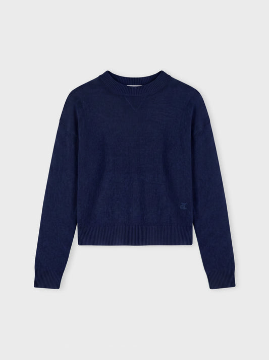 Navy blue sweater on a grey background