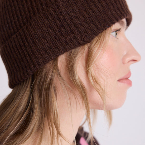 woman wearing brown beanie close up