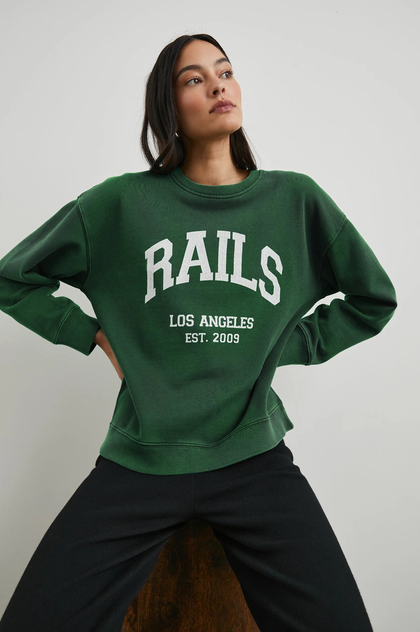 Green sweatshirt with white rails decal on the front