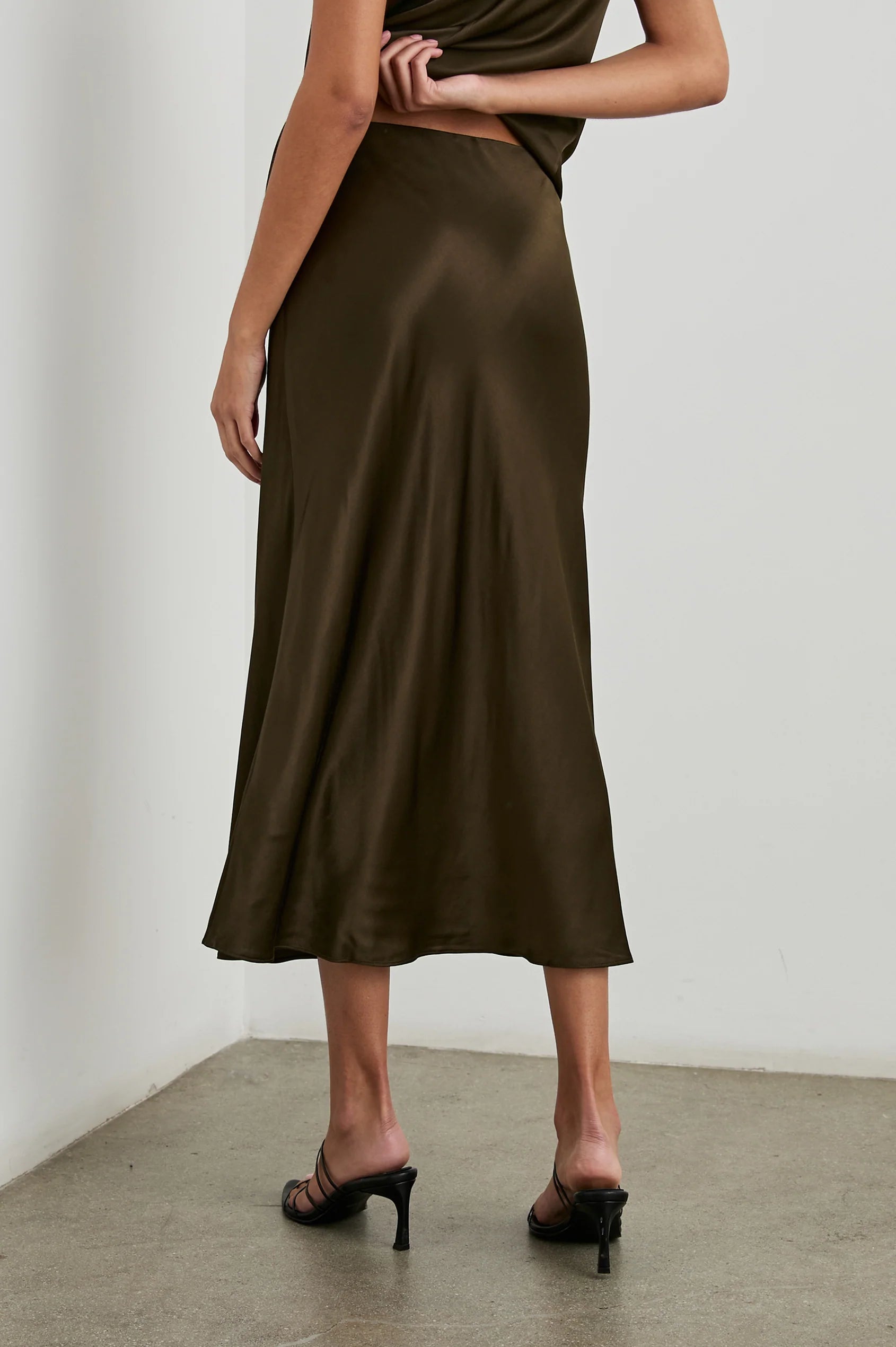 Dark brown bias cut slip skirt with elasticated waist rear view