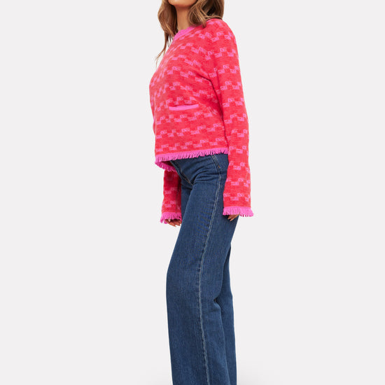 pink check cashmere jumper with 2 front pockets and frayed edge cuffs, neck and hemline side view 