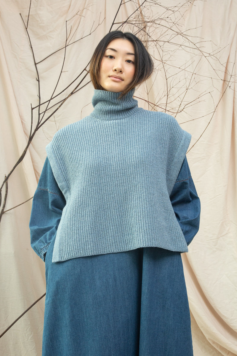 light blue knitted vest with rib detailing, sleeveless and roll neck model shot