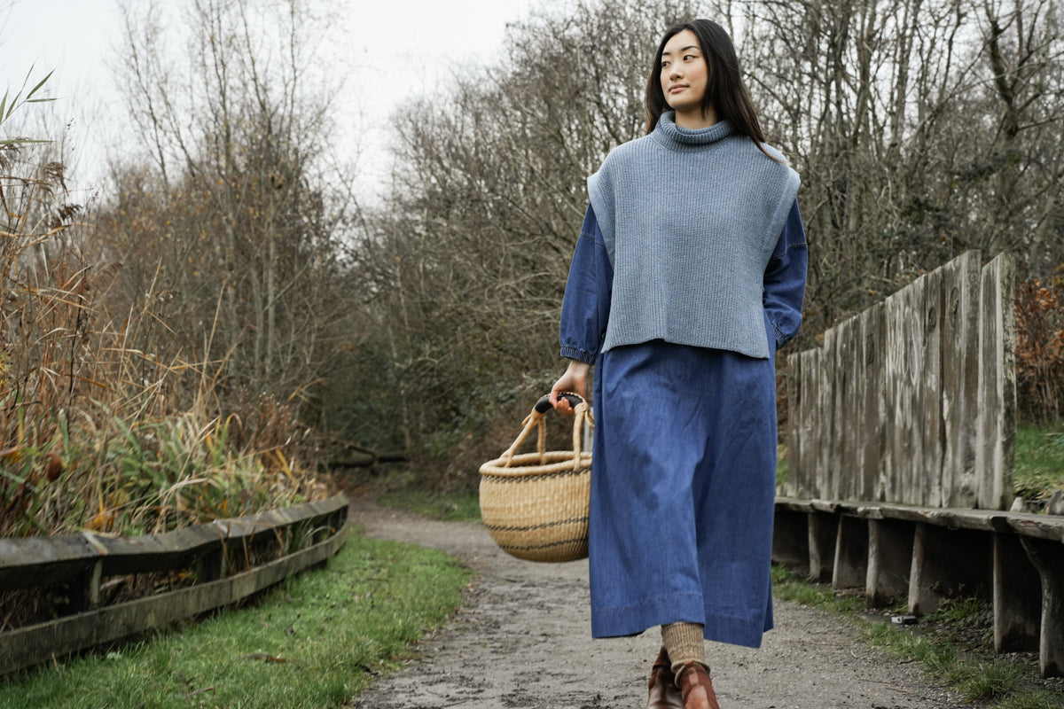 light blue knitted vest with rib detailing, sleeveless and roll neck model shot