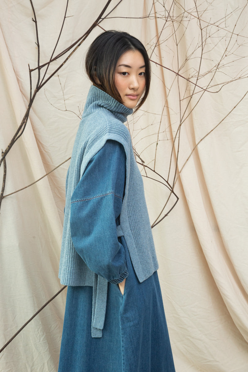 light blue knitted vest with rib detailing, sleeveless and roll neck side view