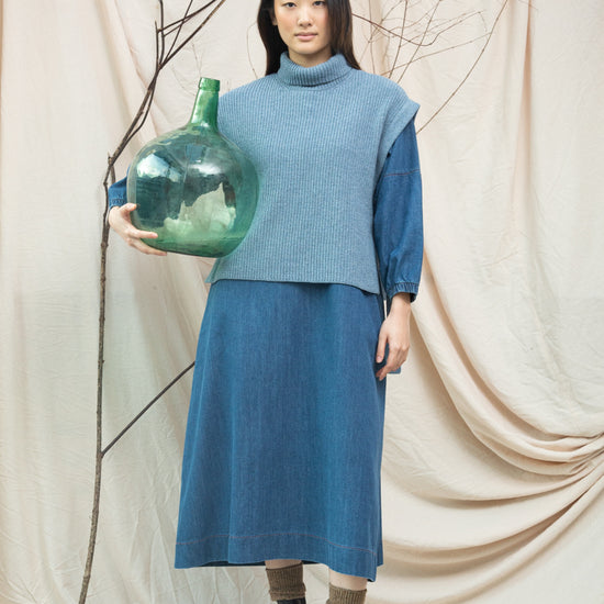 light blue knitted vest with rib detailing, sleeveless and roll neck model shot