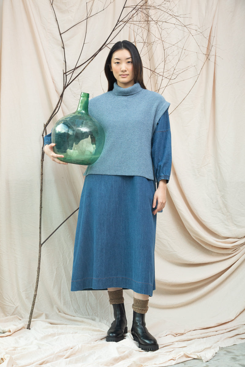 light blue knitted vest with rib detailing, sleeveless and roll neck model shot