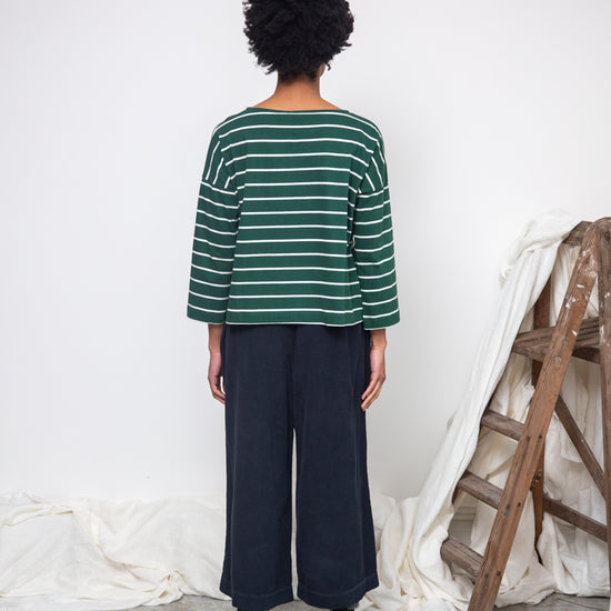 green and off white stripe top with boat neck and long sleeves rear view