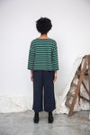 green and off white stripe top with boat neck and long sleeves rear view