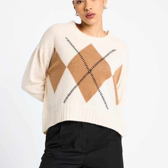 cream round neck cashmere jumper with rib detailing and tan argyle design on the front