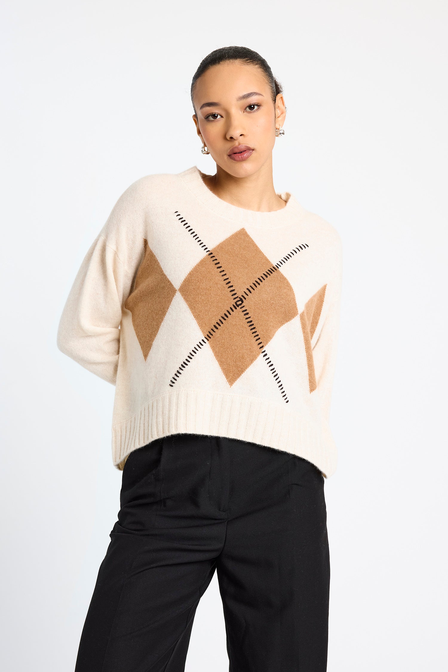 cream round neck cashmere jumper with rib detailing and tan argyle design on the front
