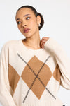 cream round neck cashmere jumper with rib detailing and tan argyle design on the front model shot