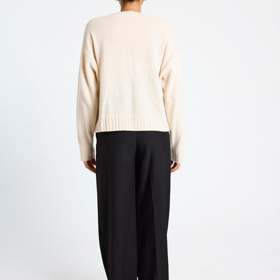 cream round neck cashmere jumper with rib detailing and tan argyle design on the front rear view