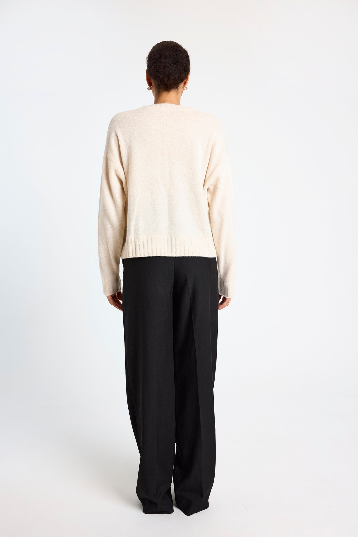 cream round neck cashmere jumper with rib detailing and tan argyle design on the front rear view